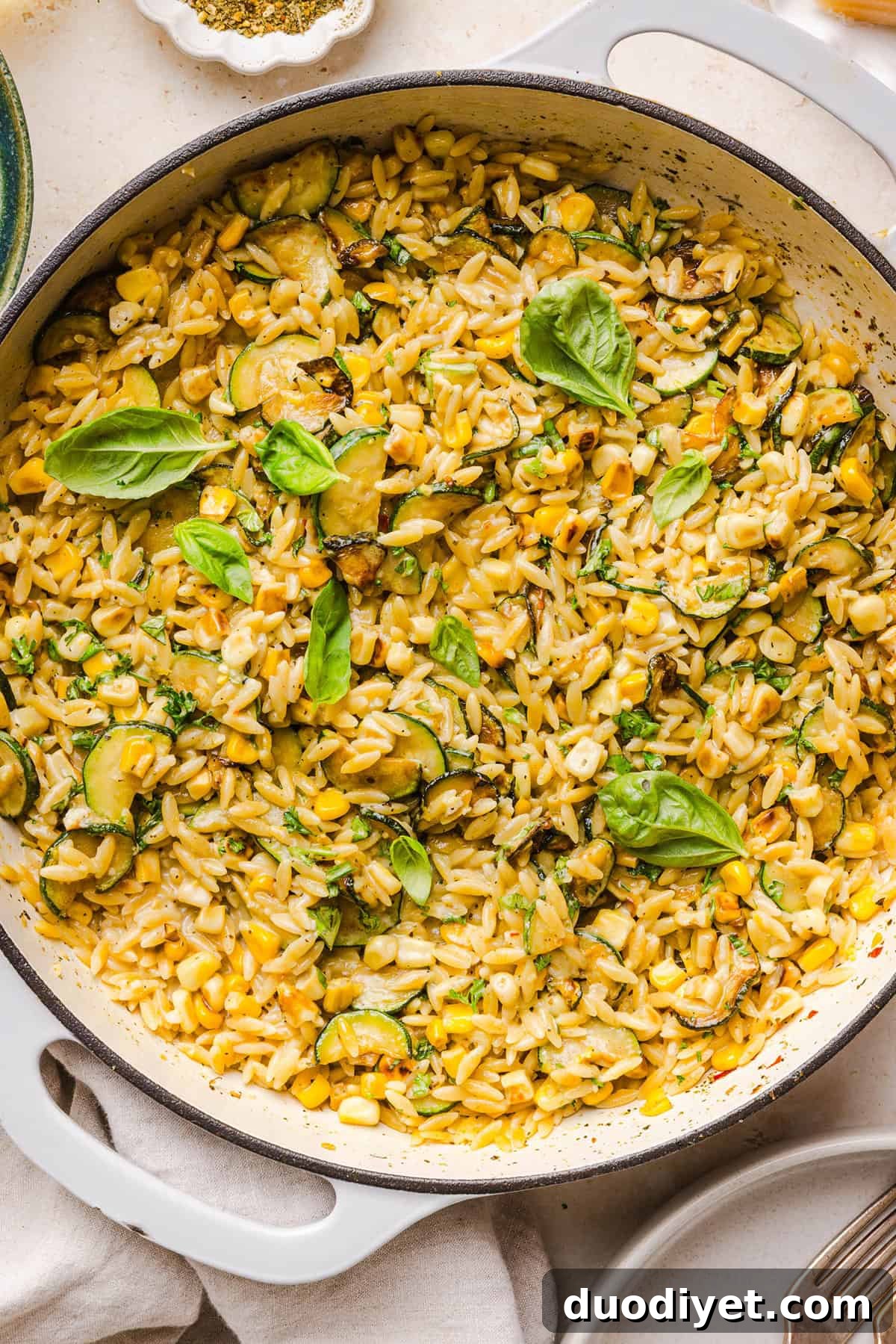 This creamy One Pan Lemon Garlic Orzo with Zucchini and Corn is fresh, flavorful and made in one skillet for an easy summer side dish or weeknight meal. Packed with fresh veggies, tender orzo, Parmesan, herbs and bright lemon flavor!