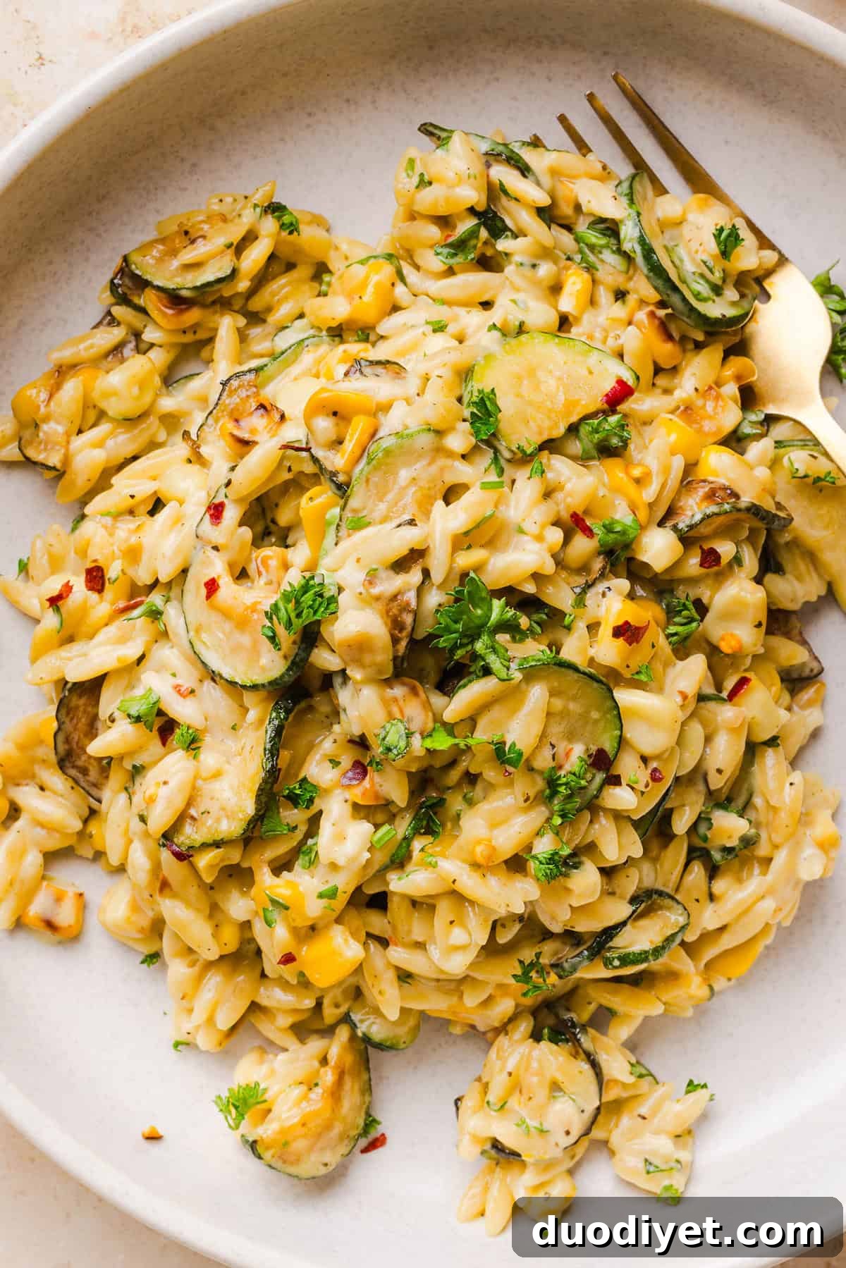 This creamy One Pan Lemon Garlic Orzo with Zucchini and Corn is fresh, flavorful and made in one skillet for an easy summer side dish or weeknight meal. Packed with fresh veggies, tender orzo, Parmesan, herbs and bright lemon flavor!