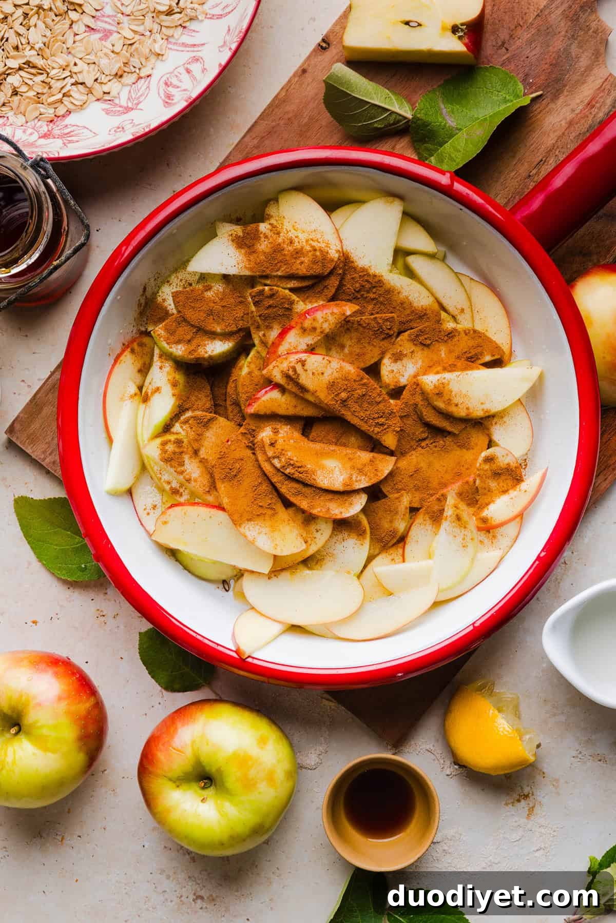 Sliced apples tossed with cinnamon, nutmeg and maple syrup to make the filling.