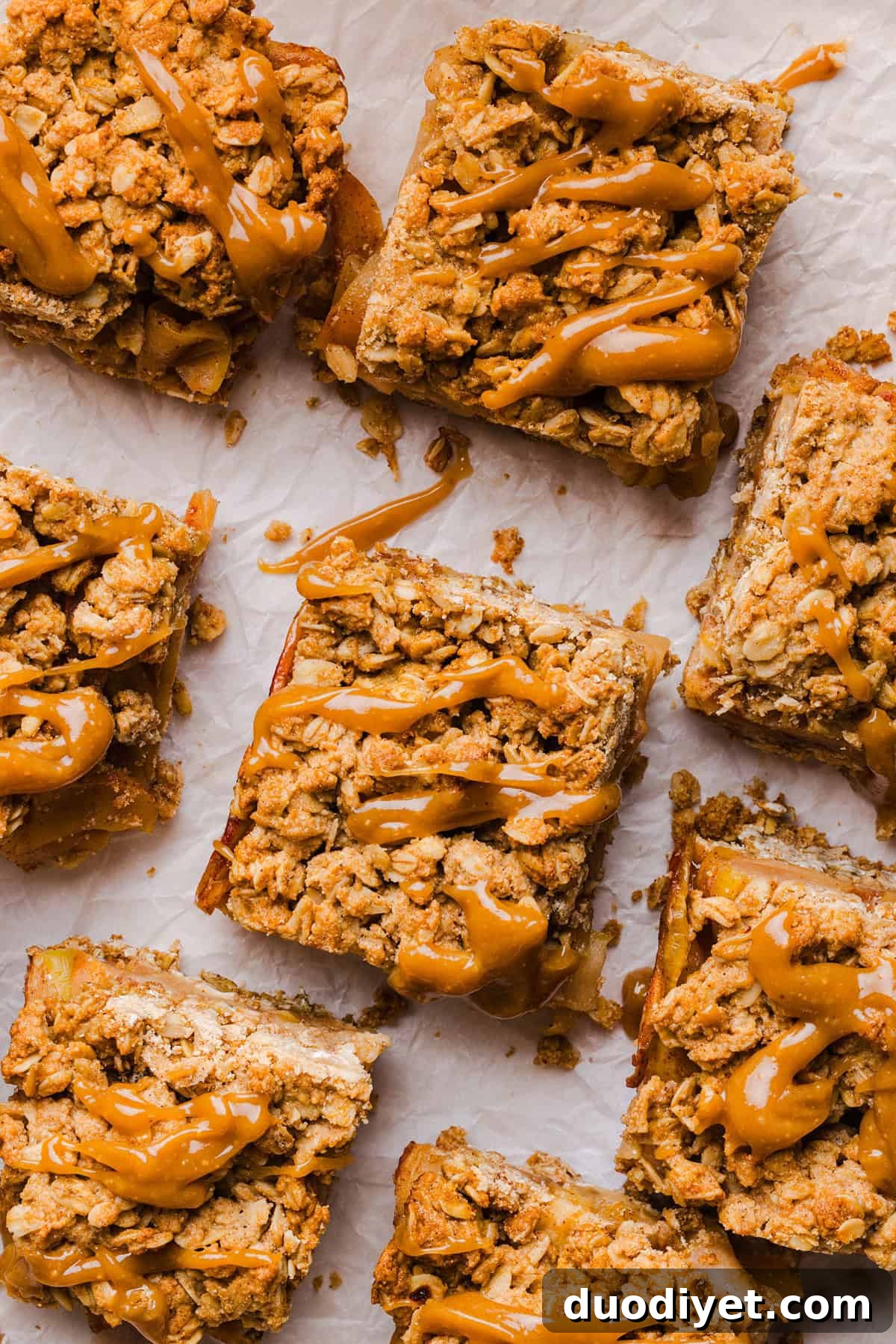 Apple pie crumble bars with a golden oat topping and maple caramel drizzle